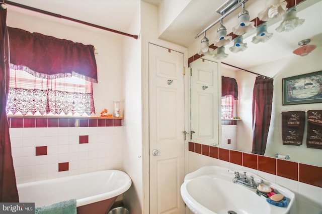 682 Duvall Hwy, Pasadena, MD 21122 - full bathroom with a freestanding tub, a sink, and tile walls