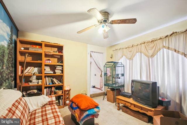 sitting room with ceiling fan and light colored carpet