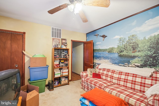 interior space with light carpet and ceiling fan