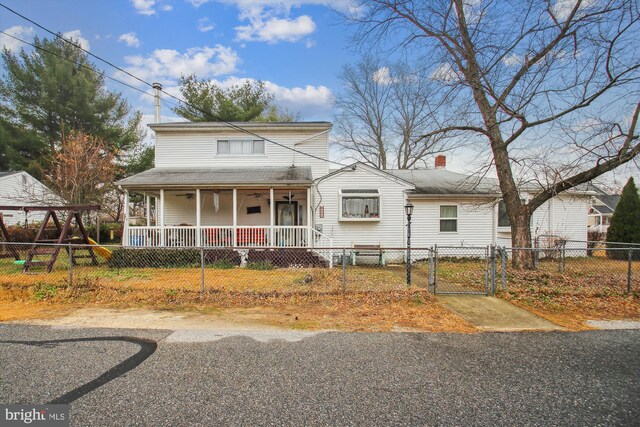682 Duvall Hwy, Pasadena, MD 21122 - back of house with oil tank, a patio area, cooling unit, a chimney, and a yard