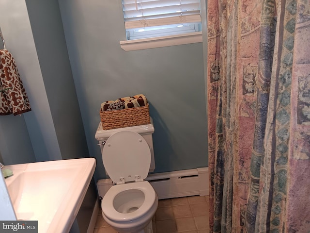 bathroom featuring tile patterned floors, toilet, and a baseboard heating unit