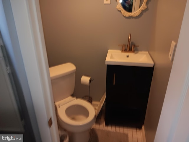 bathroom featuring vanity, toilet, and wood-type flooring