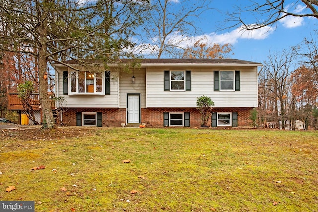 raised ranch with a front lawn and a deck