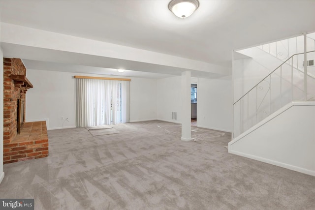 unfurnished living room featuring a fireplace and light colored carpet