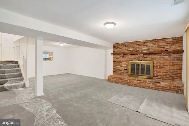 basement with carpet and a brick fireplace