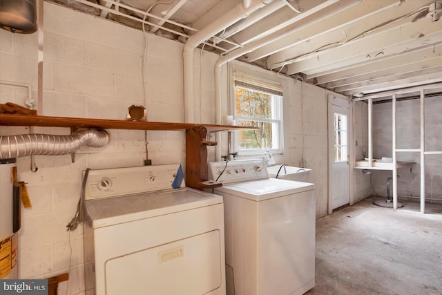 laundry area featuring gas water heater, independent washer and dryer, and sink