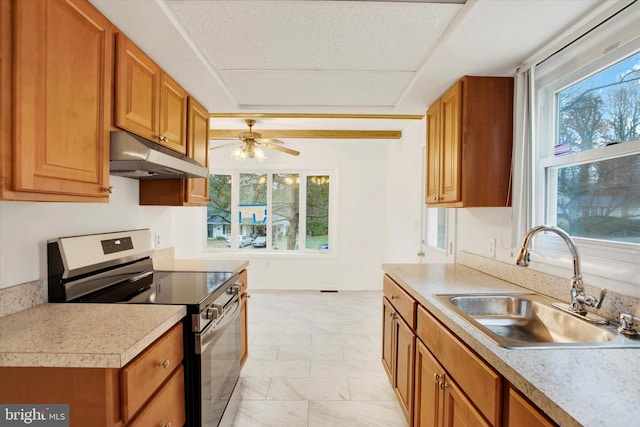 kitchen with a textured ceiling, ceiling fan, stainless steel electric range oven, and sink