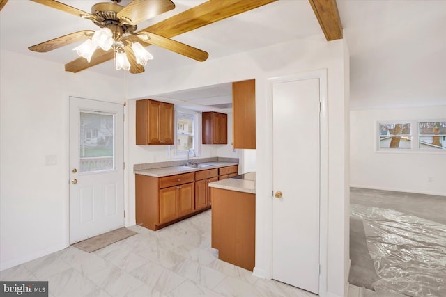 kitchen with beam ceiling, ceiling fan, and sink