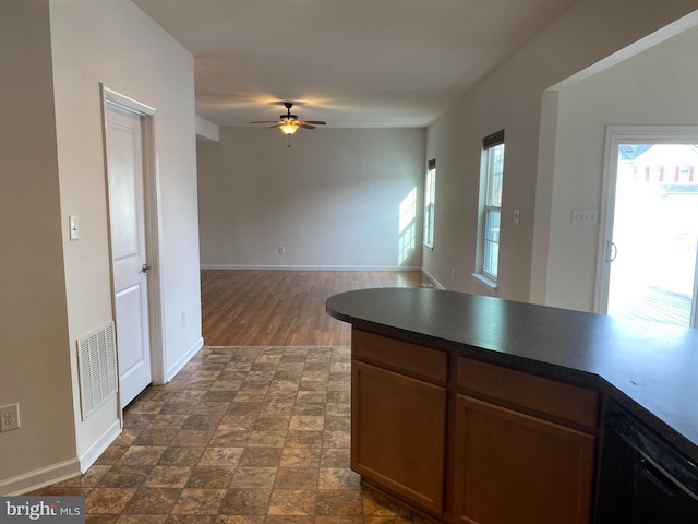 kitchen featuring ceiling fan, dark hardwood / wood-style flooring, and black dishwasher