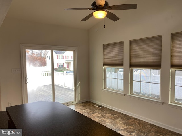 unfurnished dining area with ceiling fan and a healthy amount of sunlight