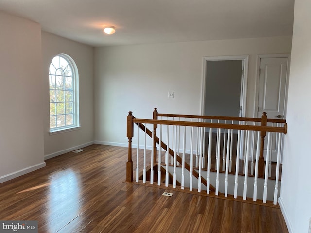 stairs featuring hardwood / wood-style floors