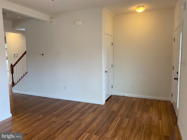 spare room featuring dark wood-type flooring