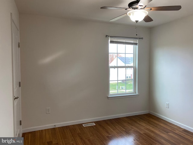 spare room with ceiling fan and dark wood-type flooring