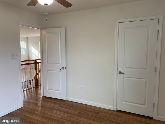 unfurnished room with dark hardwood / wood-style floors and ceiling fan