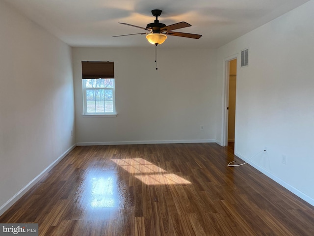 empty room featuring dark hardwood / wood-style floors and ceiling fan