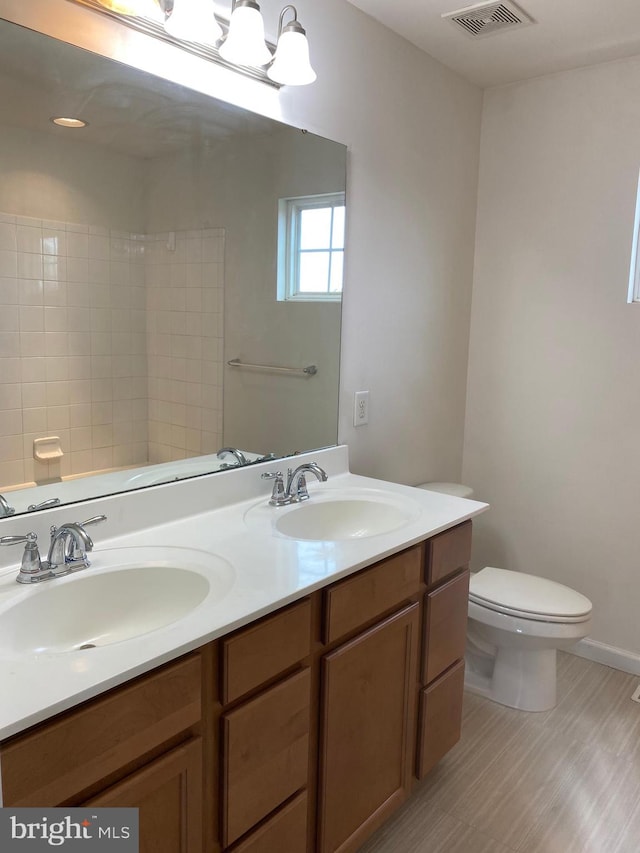 bathroom featuring vanity and toilet