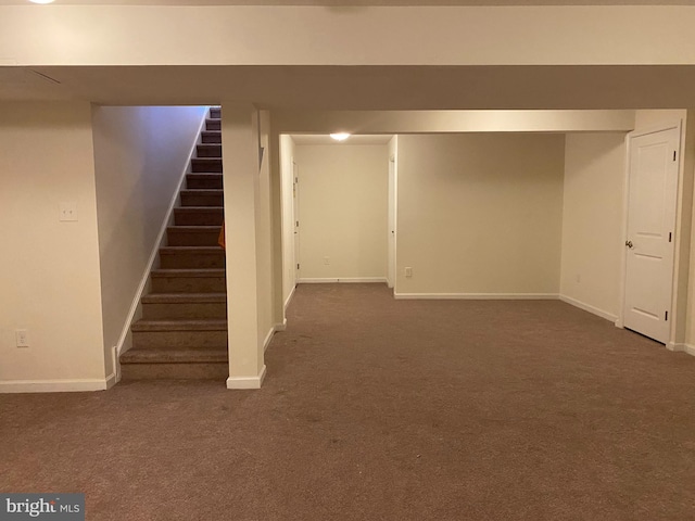 basement featuring dark colored carpet