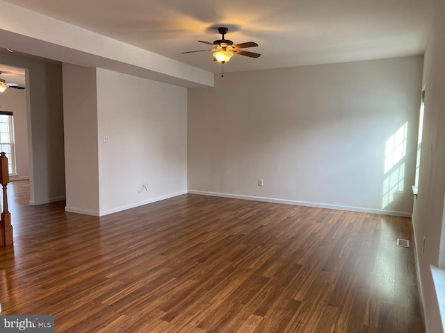 unfurnished room with ceiling fan and dark hardwood / wood-style flooring