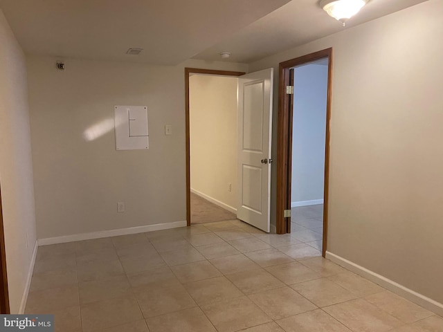 tiled empty room with electric panel