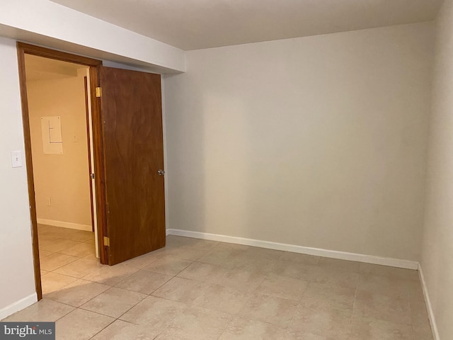 spare room featuring light tile patterned flooring