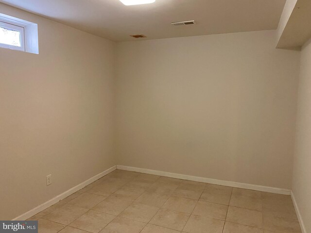 unfurnished room with light tile patterned flooring