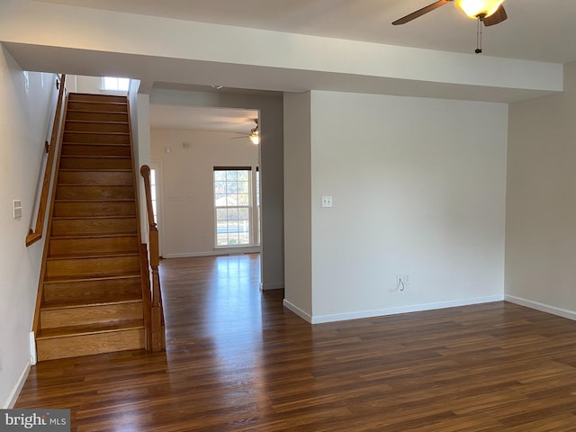 empty room featuring ceiling fan and dark wood-type flooring