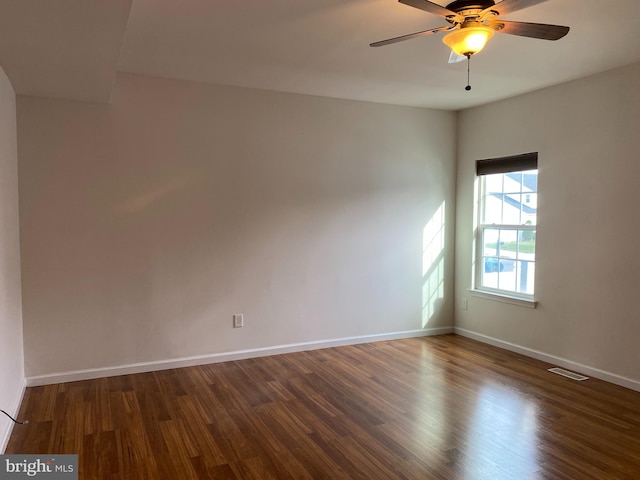 unfurnished room featuring dark hardwood / wood-style floors and ceiling fan