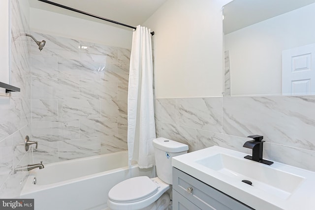 full bathroom featuring toilet, vanity, shower / tub combo with curtain, and tile walls