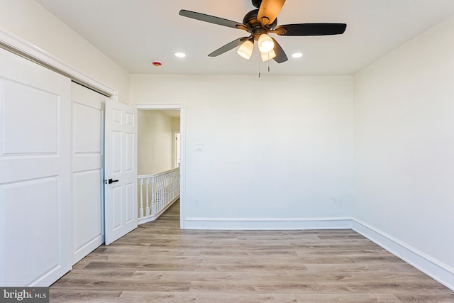 unfurnished bedroom featuring a closet, ceiling fan, and light hardwood / wood-style flooring