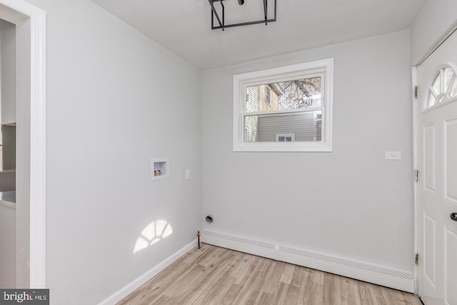 laundry area featuring light hardwood / wood-style flooring, a baseboard radiator, and washer hookup