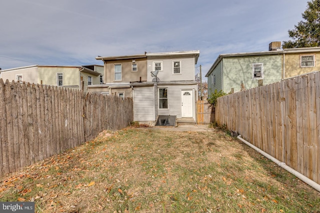 rear view of house featuring a lawn