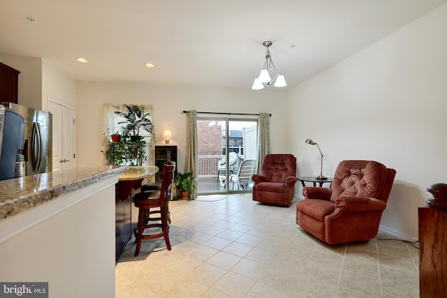 tiled living room featuring an inviting chandelier