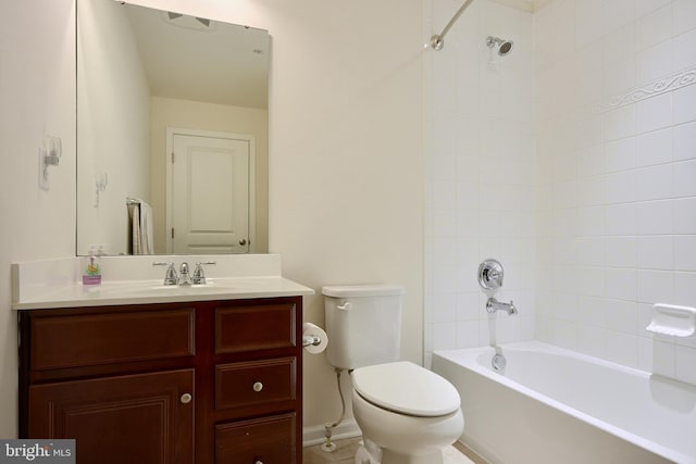 full bathroom featuring tiled shower / bath, vanity, and toilet