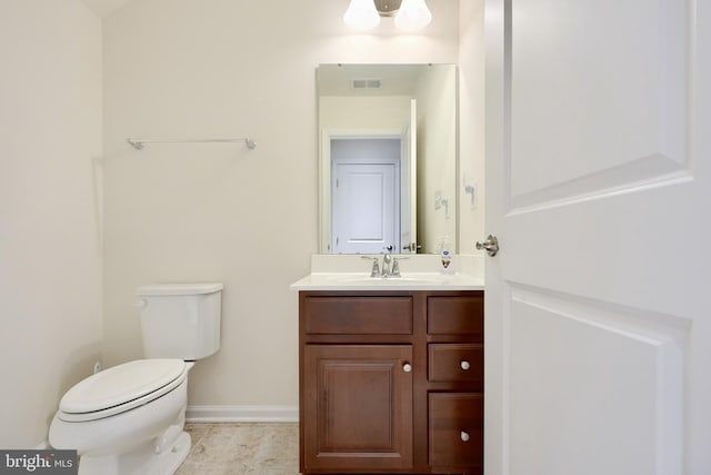 bathroom featuring tile patterned floors, vanity, and toilet