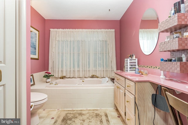 bathroom with tile patterned flooring, vanity, a relaxing tiled tub, and toilet