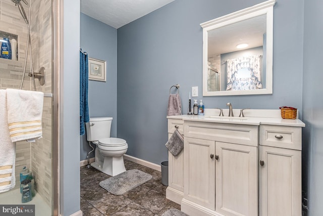 bathroom with toilet, vanity, tile patterned floors, and walk in shower