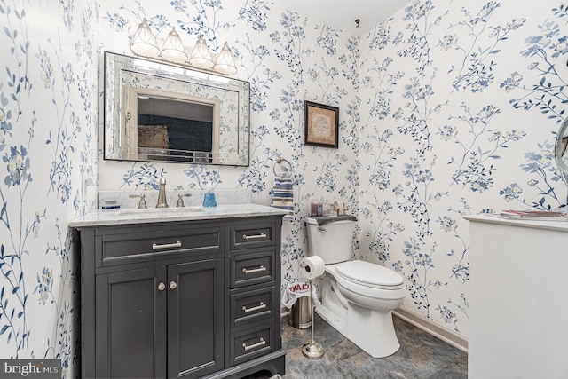 bathroom featuring vanity and toilet