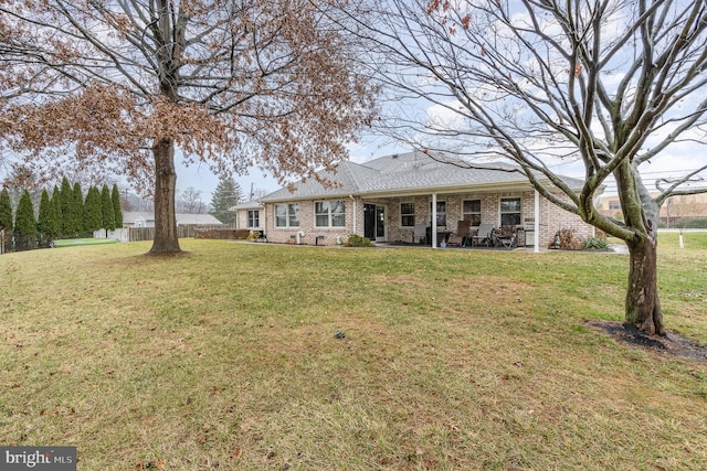 back of property with a lawn