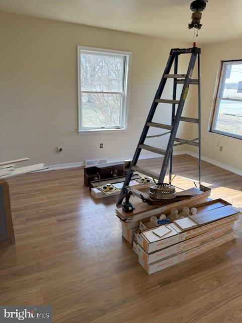 workout area featuring baseboards and wood finished floors