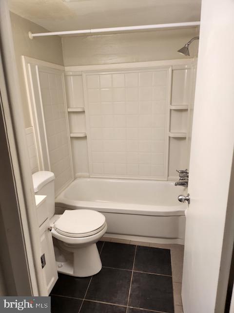 full bathroom featuring toilet, vanity, tile patterned floors, and shower / washtub combination