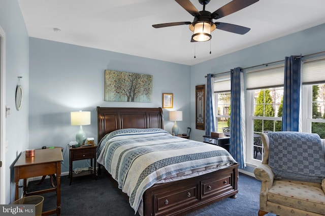 bedroom featuring dark colored carpet and ceiling fan