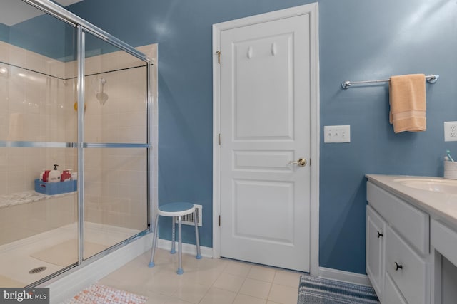 bathroom featuring tile patterned floors, vanity, and a shower with shower door