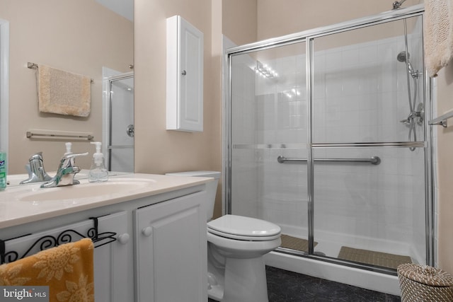 bathroom with vanity, toilet, and walk in shower