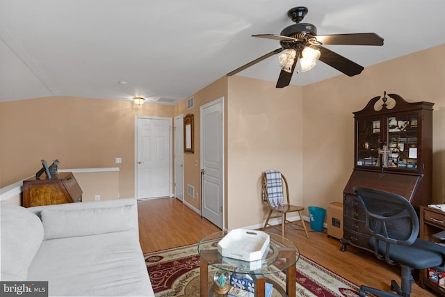 living room with wood-type flooring and ceiling fan