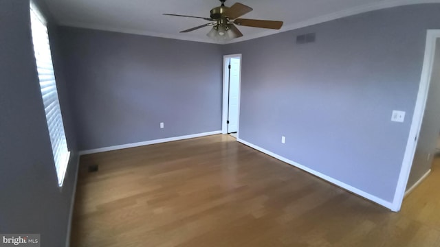 unfurnished room with dark hardwood / wood-style floors, ceiling fan, and ornamental molding