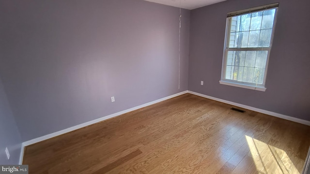 unfurnished room with light hardwood / wood-style flooring