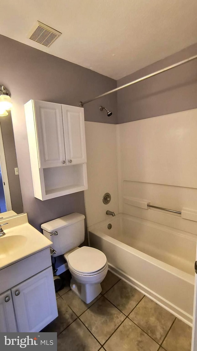 full bathroom featuring tile patterned flooring, bathtub / shower combination, vanity, and toilet