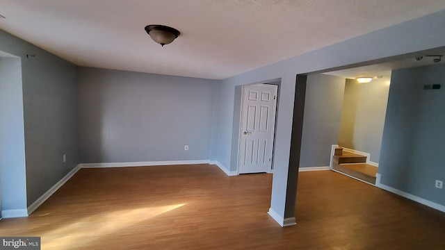 basement with hardwood / wood-style floors