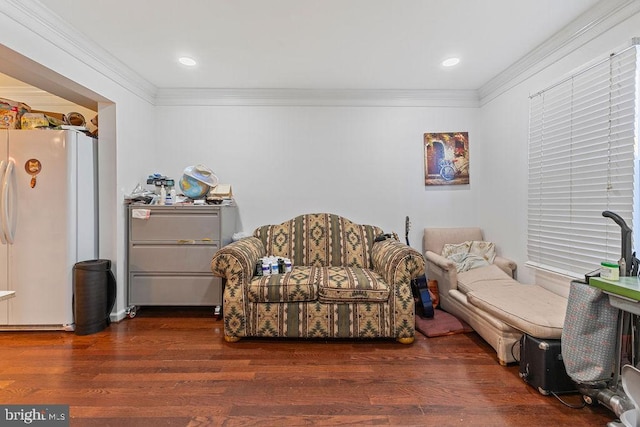 sitting room with dark hardwood / wood-style floors and ornamental molding