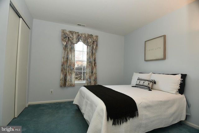 bedroom featuring dark carpet and a closet